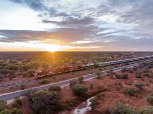 The Ghan train crossing through bushland at sunrise in remote South Australia