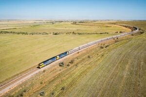 Indian Pacific train stretching across vast green plains in rural South Australia