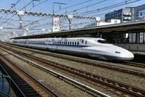 Japanese Shinkansen bullet train at a station platform, representing high-speed rail travel across Japan