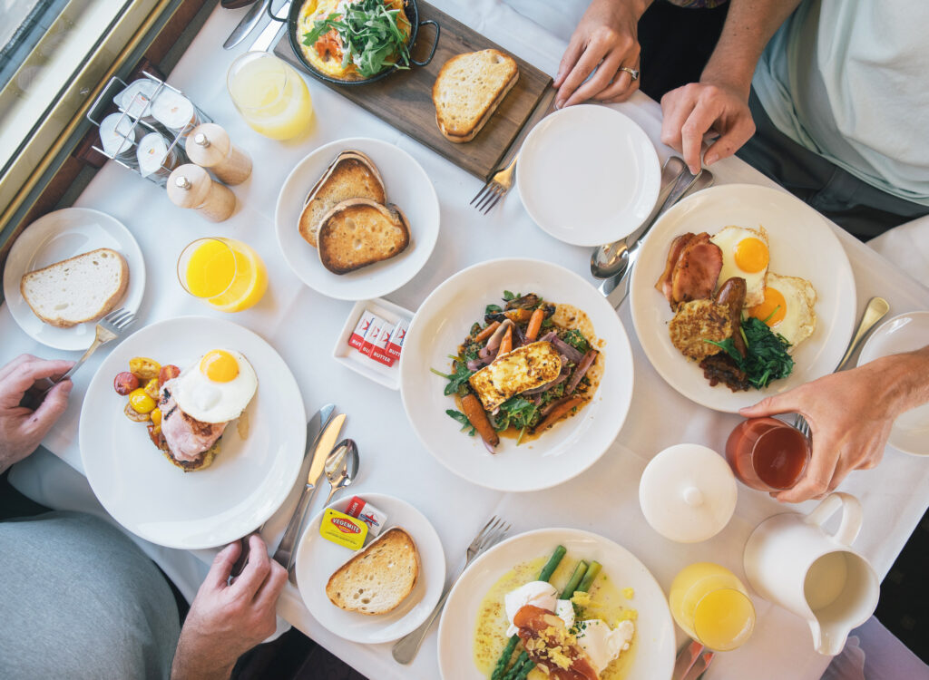 A full gourmet breakfast with eggs, toast, and juices served on The Overland.