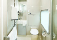Spacious and modern ensuite bathroom with shower, toilet, and vanity in Gold Service cabin.