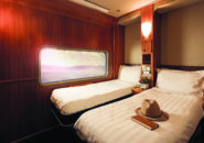 Stylish twin Platinum Service cabin onboard the Great Southern with large window and luxury bedding.